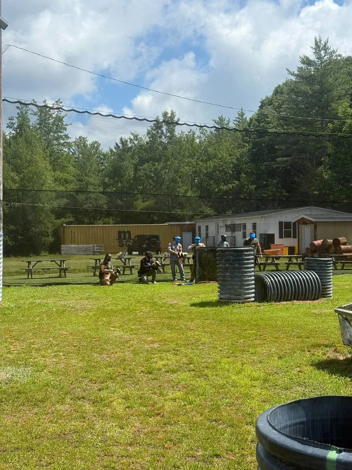 Masked players lined up by Hyperball pipe bunkers